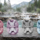 Fähloo in Desert Rose, French Lilac, Pebble Grey and Sea Salt Blue on a rock by a hot spring